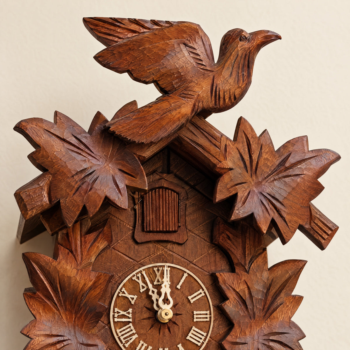 Close-up of the dial and carving of a Black Forest cuckoo clock